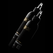 Two black tattoo machines with gold branding on a black background