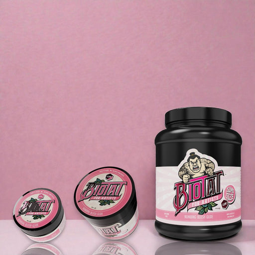 Biotat Glide Blush tattoo glide jars in multiple sizes displayed on a matte studio surface with blush-toned background
