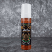 Red Out bio-active calming foam bottle on a gray background