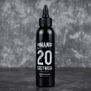 Black tattoo ink bottle labeled 'Dynamic Greywash 20' on a dark background
