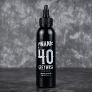 Black bottle of Dynamic Greywash on a dark background