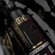 Close-up of a motorcycle with 'INX' branding on a dark background