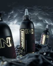 Black tattoo ink bottles with 'INX' branding on a dark, textured background