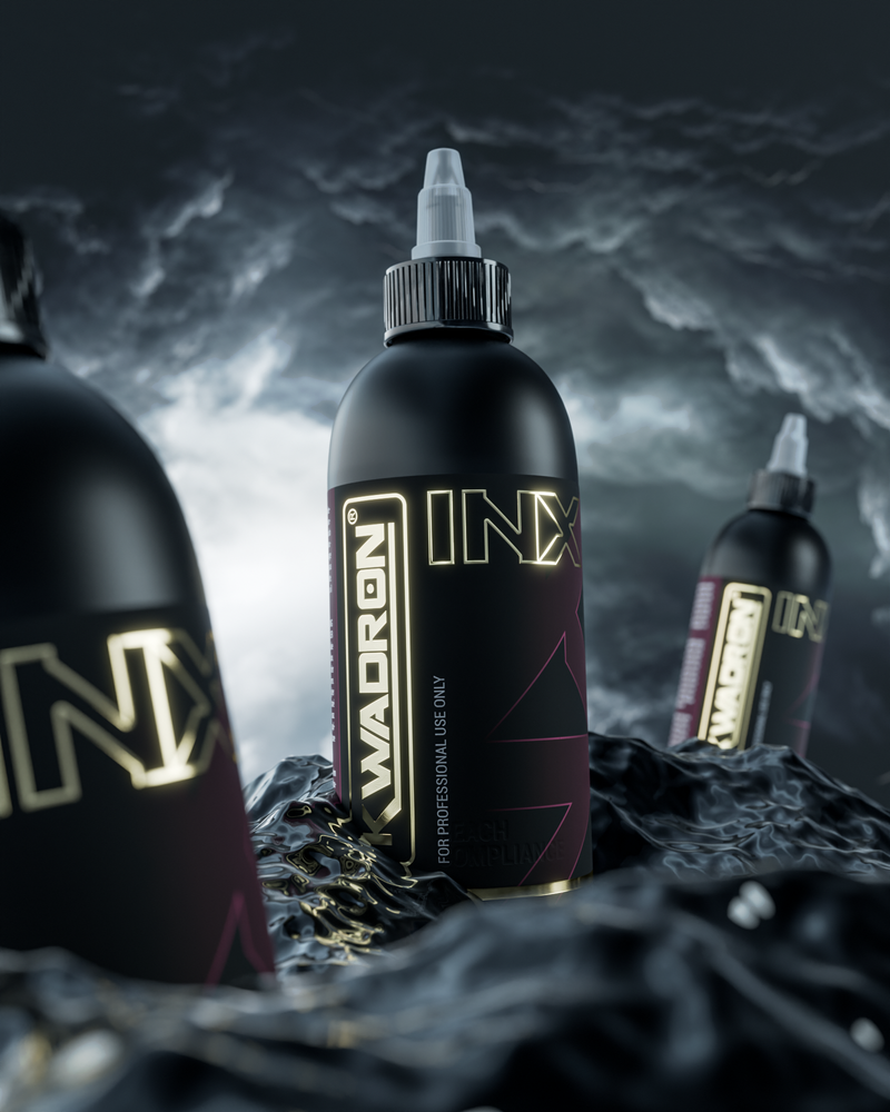 Black tattoo ink bottles with 'INX' branding on a dark, textured background